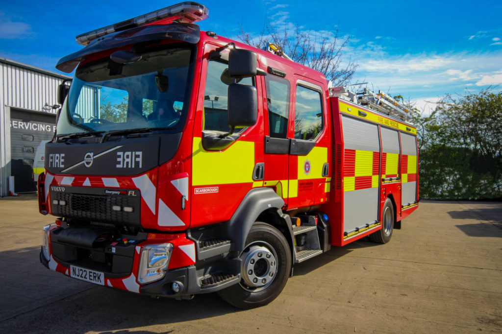 large red fire appliance with hi-vis markings